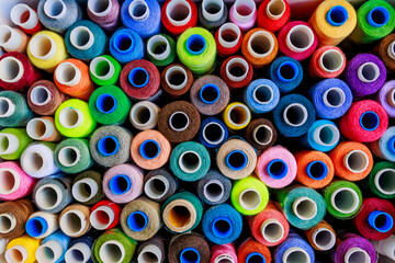 set of multi-colored spools of thread for sewing close-up