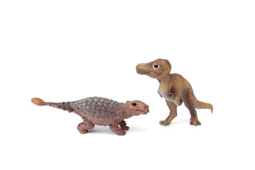 Mini Dinosaur toy. The Cretaceous Rivals. Baby Tyrannosaurus rex and Baby Ankylosaurus isolated on white background.