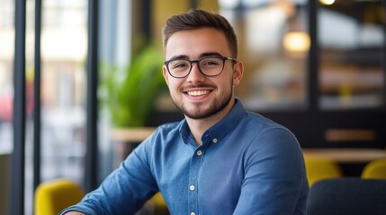 Obraz premium Happy young man in blue shirt with a beard smiling Cheerful Business Professional Working