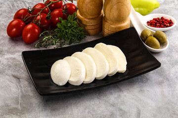 Organic mozzarella cheese slices in the plate