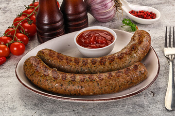 Grilled beef sausages with sauce