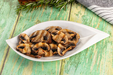 Tasty hot grilled champignon mushrooms