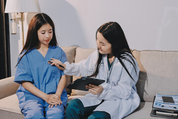 A doctor uses a stethoscope to check the heartbeat of his patient. Patients must undergo a yearly...