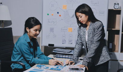 Group of young application developers analyzing uxui mobile app templates during a working meeting