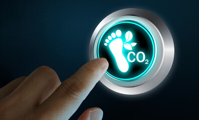 Finger pressing CO2 carbon footprint button with glowing eco icon, concept of sustainability and...