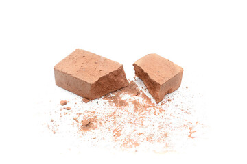 Close-up of shattered brick pieces isolated on a white background