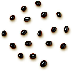 A collection of glossy black beans scattered on a light background.