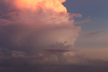 Majestic Sunset Over Dramatic Clouds Illuminated by Warm Hues of Pink and Orange Offering a Serene...