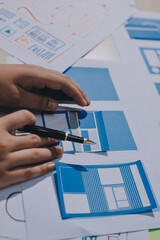 Group of young application developers analyzing uxui mobile app templates during a working meeting