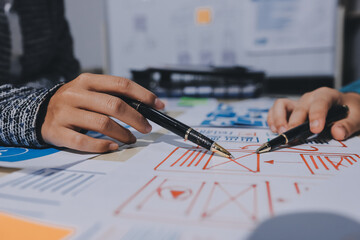 Group of young application developers analyzing uxui mobile app templates during a working meeting