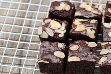 Delicious Chocolate Brownies with Almond Slices on Cooling Rack Perfect for Dessert Lovers and Home...
