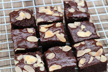 Deliciously Rich Chocolate Brownies with Almond Slices on a Cooling Rack, Perfect for Dessert Lovers and Home Bakers Seeking Tempting Treats