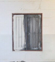 Weathered Wooden Window Frame on a White Wall Showcasing Distressed Beauty and Unique Textures, Perfect for Architectural or Home Decor Inspiration