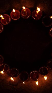 Vertical video of Indian festival Diwali, Closeup Festival Diya or Oil Lamp with Glowing Flame, diwali festive of light celebration background animation for social media story.