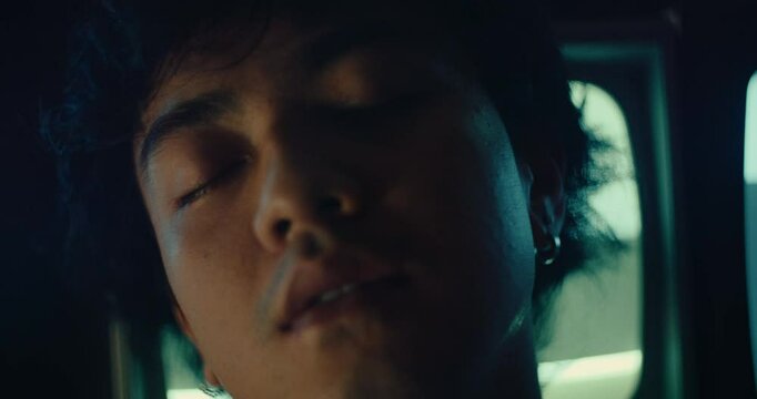 portrait close up of young alternative male sleeping and dreaming with cat tv on background