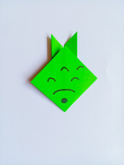 Green fish origami isolated on white background.