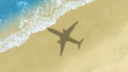 Aerial view of shadow passenger plane silhouette and sandy beach blue sea with waves at sea beach summer vacation sea travel concept	
