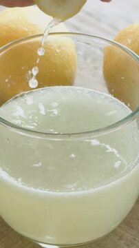 Hand Squeezing Fresh Lemon Juice.