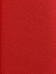 Close-up of a vibrant red textured surface, possibly leather or leatherette, exhibiting a consistent, pebbled grain