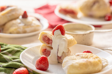 vareniki with fresh strawberry filling, powdered sugar, and cream. Suitable for visual menus, stock food libraries, or artisan culinary branding.