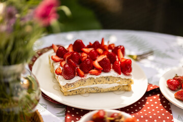 Layered crepe dessert with whipped cream and fresh fruit. Sunny afternoon picnic scene.