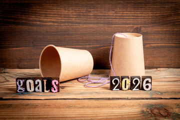 2026 Goals Concept. Paper Cup Phone  on Wooden Table