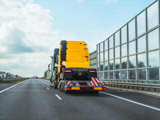 Two large trucks on transport vehicle