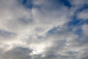 The sky is cloudy and the sun is shining through the clouds