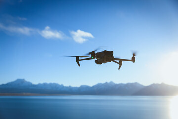 Drone flying under blue sky