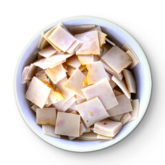 A bowl filled with small, square slices of a light-colored deli meat.