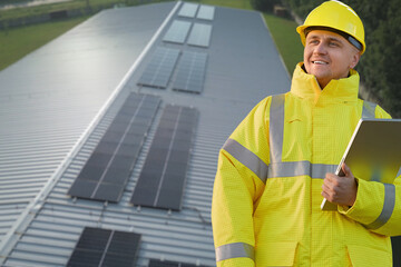 Smiling engineer overseeing solar panel installation
