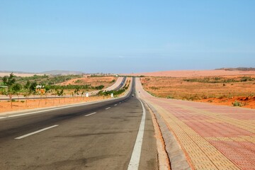 Scenic Highway Journey. Asphalt Road Through Desert, Blue Sky and Unique Landscape. Mui Ne, Vietnam.