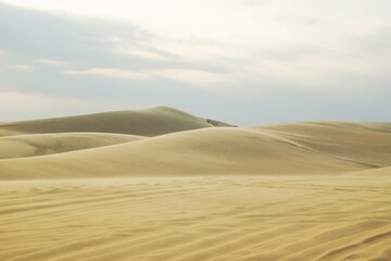 Sand Landscape with Cloudy Sky. Desert Scene for Travel and Adventure. Mui Ne, Vietnam, White Dunes.