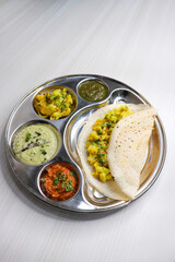 Crispy Masala dosa is a popular South Indian food item served with tomato chutney, coconut chutney, spicy potato masala, or aloo ki sabzi and sambar. Copy space. Crunchy Rice crepes.