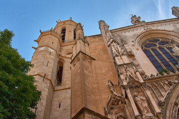 Obraz premium Detail of the tower of Saint Sauveur Cathedral in Aix en Provence with Gothic and Romanesque architecture under a radiant blue sky