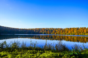 View of the Pulvermaar in the Volcanic Eifel. Nature in the Eifel National Park. Badesse near Daun with the surrounding landscape.
