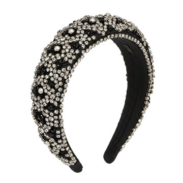 A black headband adorned with sparkling rhinestones. The design features intricate patterns and a glossy finish, suitable for formal or casual wear.