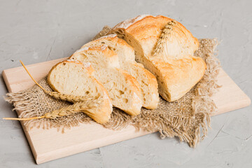 Assortment of freshly sliced baked bread with napkin on rustic table top view. Healthy unleavened...