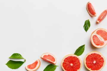fresh Fruit grapefruit with Juicy grapefruit slices on colored background. Top view. Copy Space. creative summer concept. Half of citrus in minimal flat lay with copy space