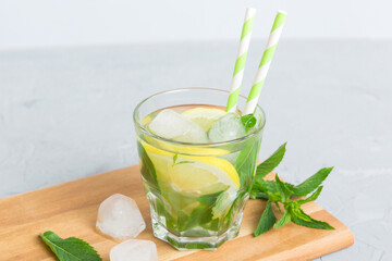 Mojito cocktail. Refreshing mojito cocktail with lime, lemon and mint in a tall glass with a stick