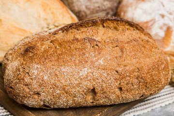 Homemade natural breads. Different kinds of fresh bread as background, perspective view with copy...