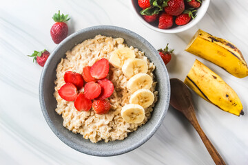 a bowl of oatmeal with strawberries and bananas
