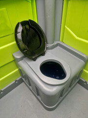 plastic mobile toilet lying on its side. Overturned thanks to vandalism, drunkards, football...