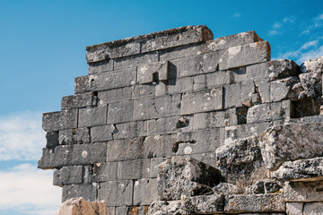 Dark stone wall ruins from ancient Sagalassos contrasting against bright sky in Burdur region