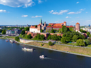 Poland, Krakow. Wawel Cathedral and Polish state owned Royal Wawel castle. Vistula river with tourist ships and boats, small harbor, boulevards, parks, walking and biking people. Copy space