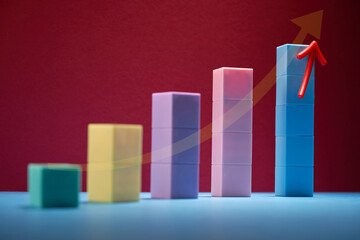 Colorful bars ascending in height from shortest to tallest with arrow sign