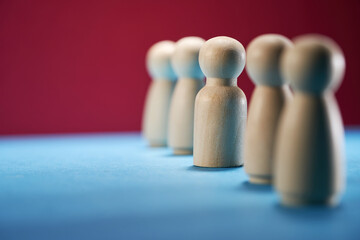 Wooden figure standing out from crowd for show influence and empowerment. Concept of business leadership