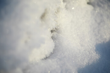 Close-Up of Fresh Snow with Soft Texture and Shimmering Crystals in Natural Sunlight