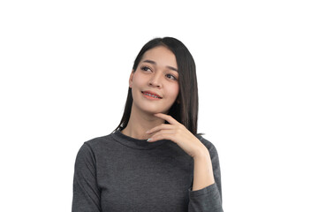 Thoughtful woman with braces smiling while looking upwards in a grey sweater against a transparent...