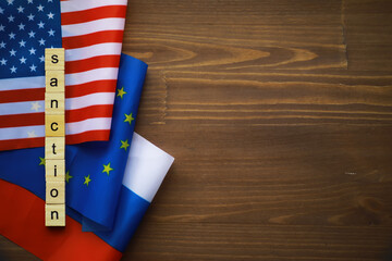 Sanction Concept with United States, European Union, and Russia Flags on Wooden Background
